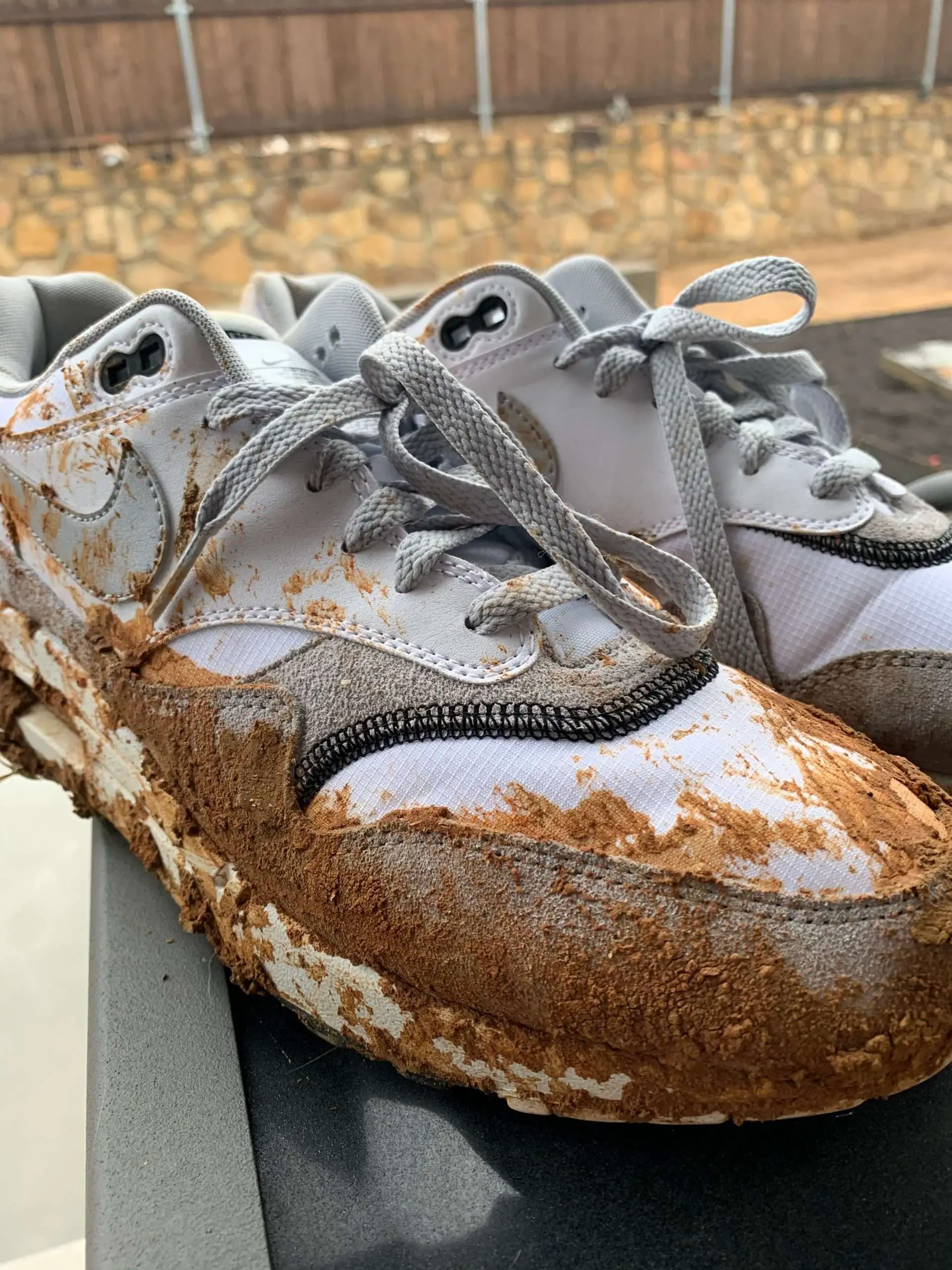 Clay on white athletic shoes